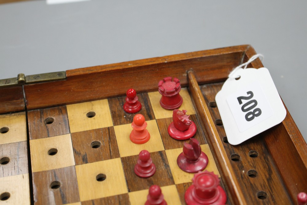 A late 19th century Jaques , London Travelling In Statu Quo travelling chess set, the folding mahogany case containing a boxwood and